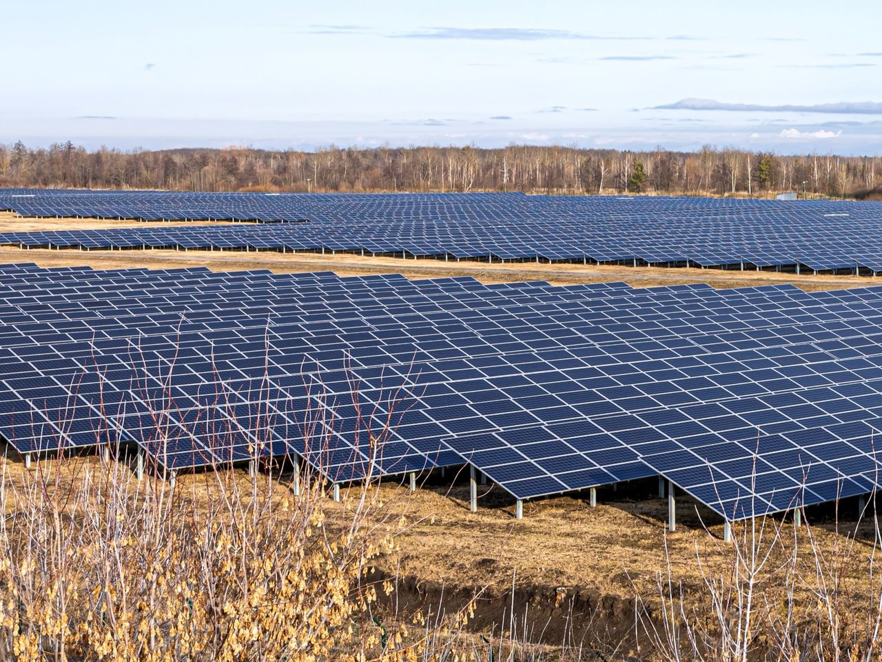Rows of ground-mounted solar arrays on steel mounting structures